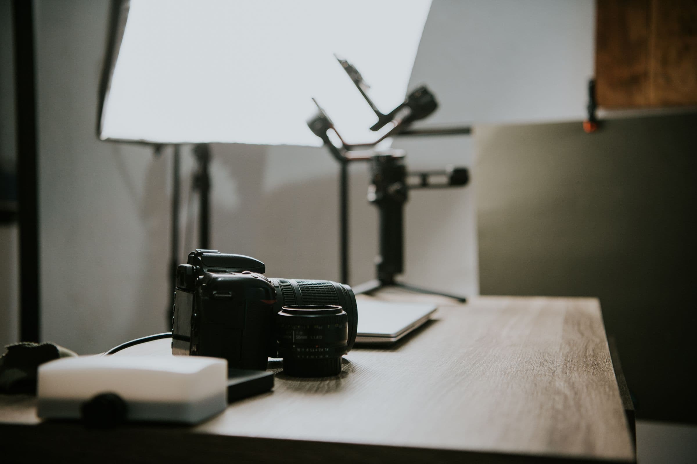 A camera body and softbox set up in a quiet, daylit studio.